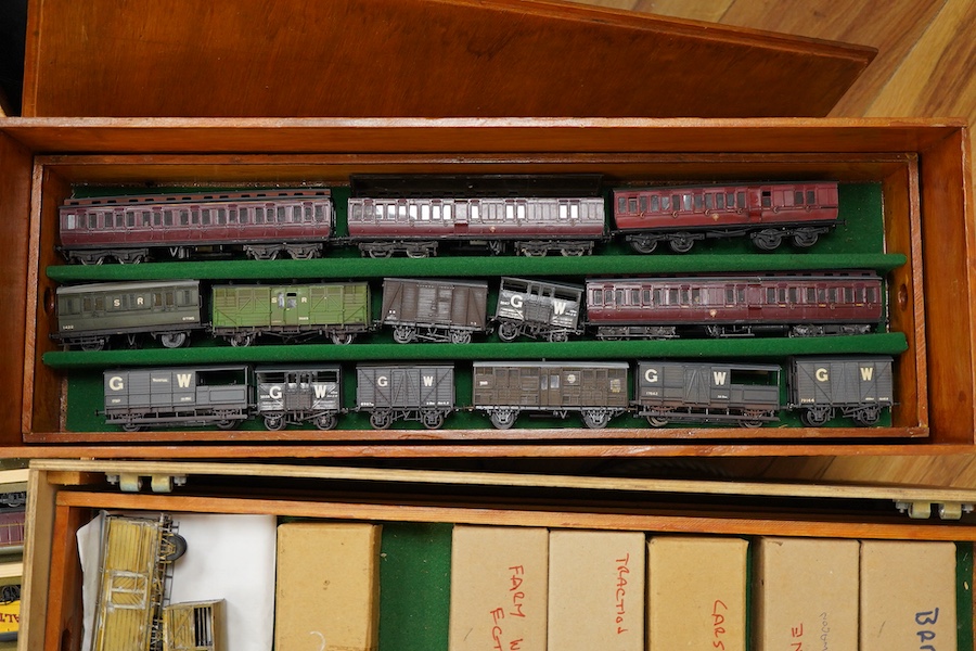 130 items of EM gauge model railway rolling stock contained within three handmade fitted wooden cases, two with removable trays, comprising three locomotives; an SR class 700 0-6-0 tender locomotive, 693, an SR 0-4-0T, 7